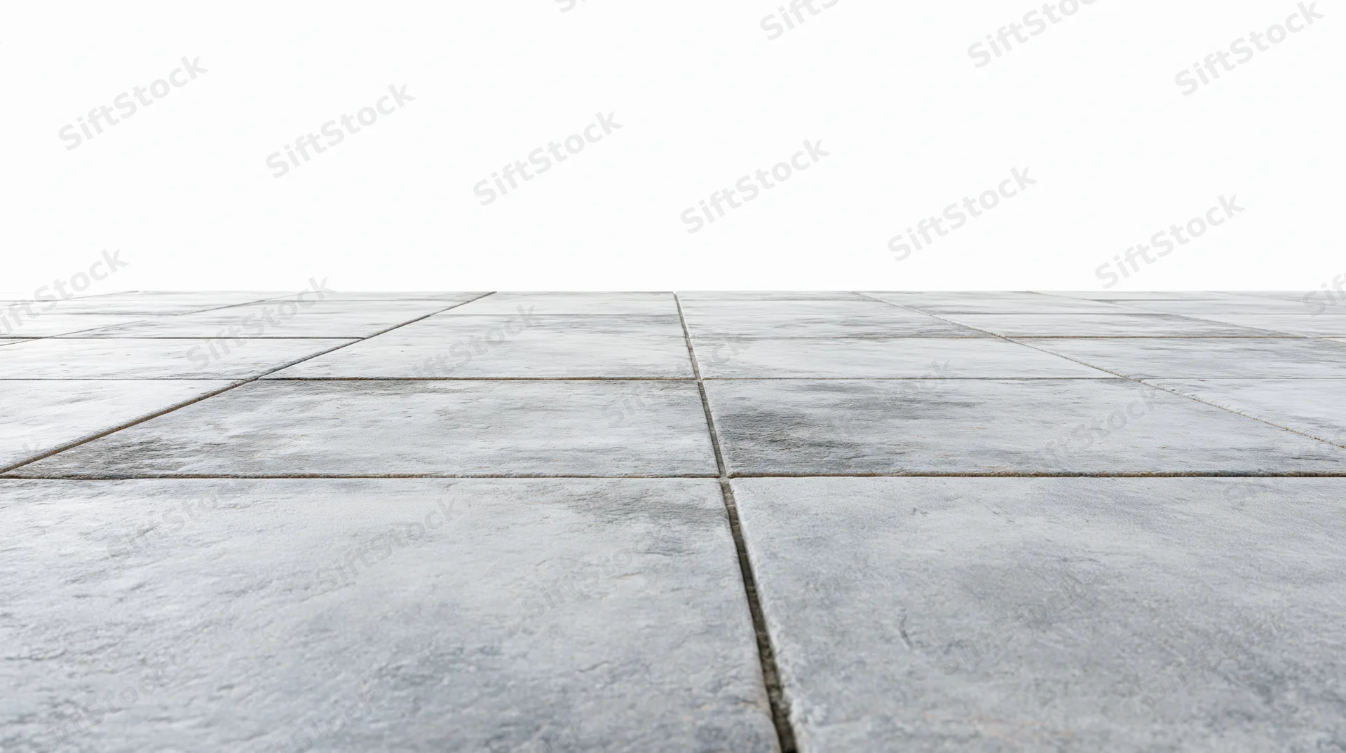 Concrete tile floor receding into perspective from low angle