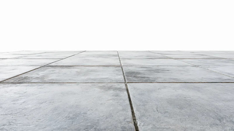 Concrete tile floor receding into perspective from low angle