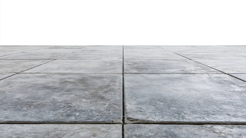 Concrete tile floor receding into perspective with white background