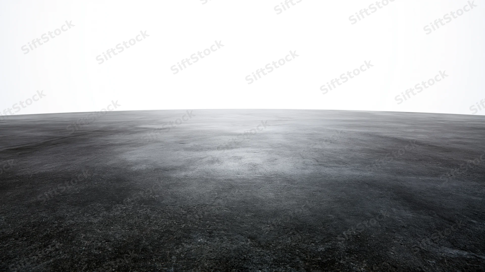Dark concrete floor surface extending to a clean white background