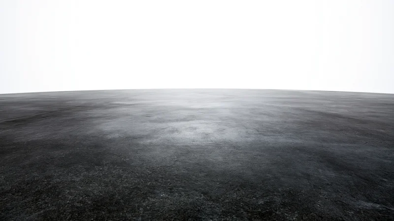 Dark concrete floor surface extending to a clean white background