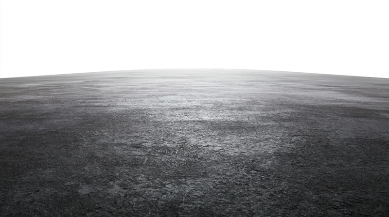 Dark concrete floor surface extending to a white background