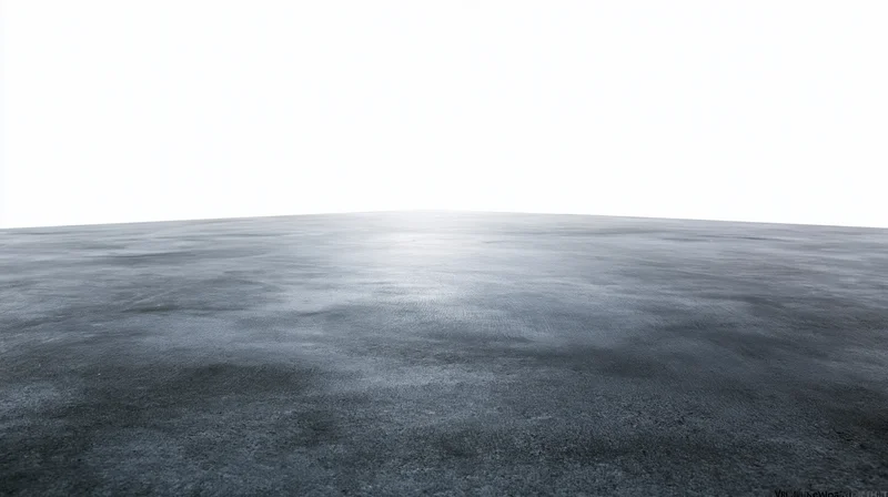 Dark concrete floor surface extending to a clean white backdrop
