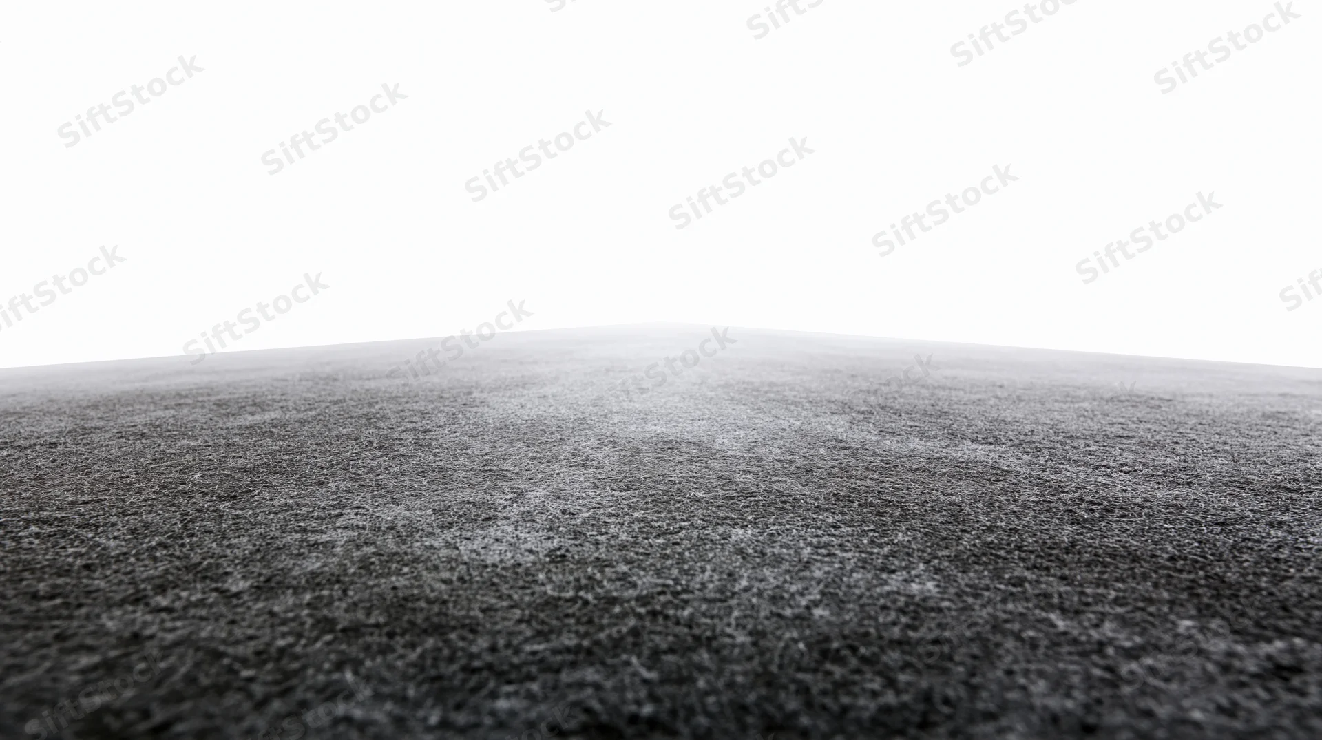 Dark concrete floor surface extending to white background