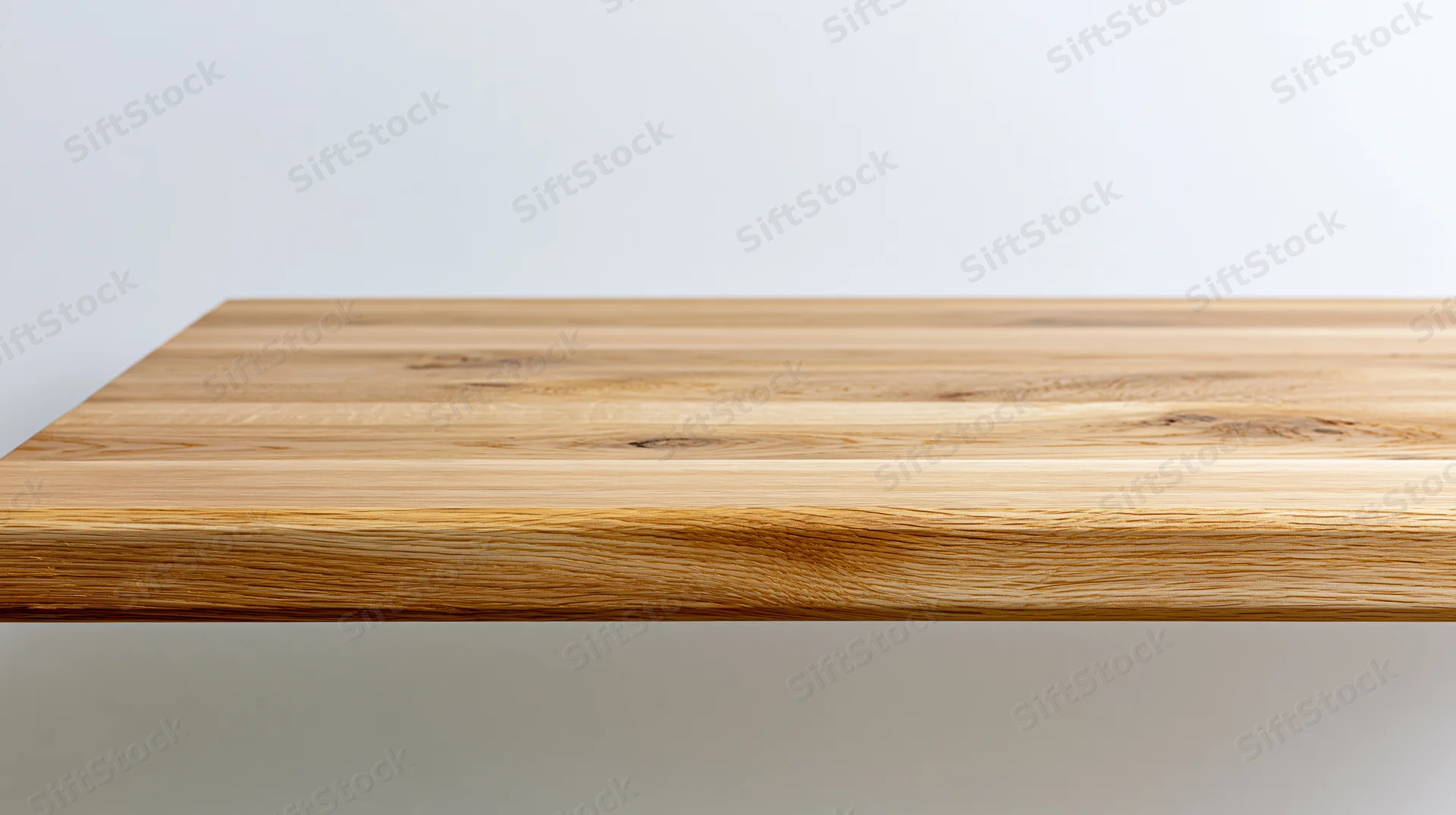 Light oak wooden tabletop surface viewed from slightly above against white background