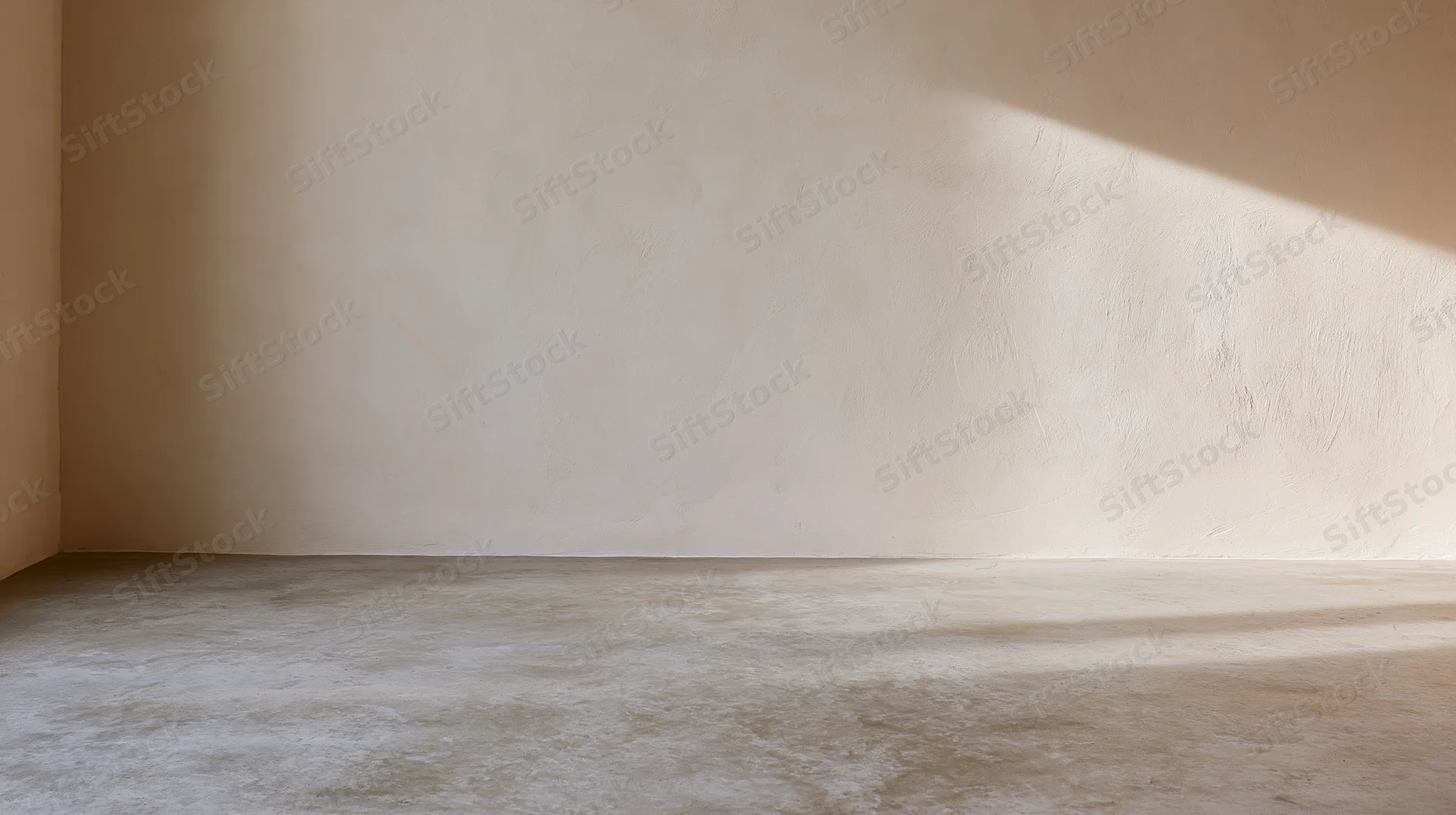 Empty room interior with bare plaster wall and concrete floor