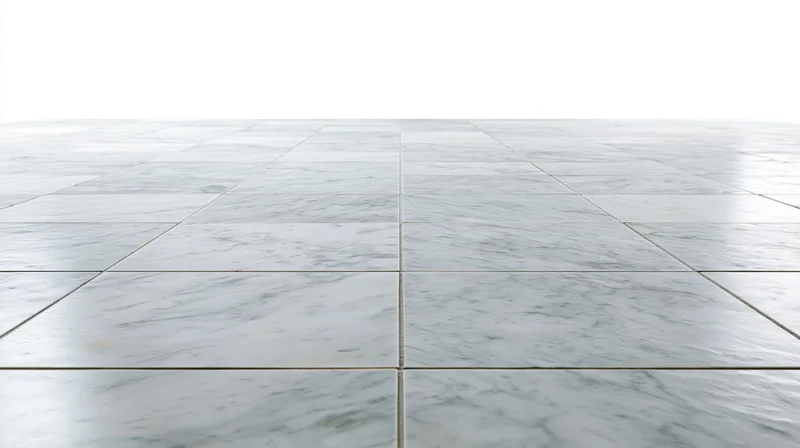White marble tile floor extending into perspective with grout lines and reflective surface