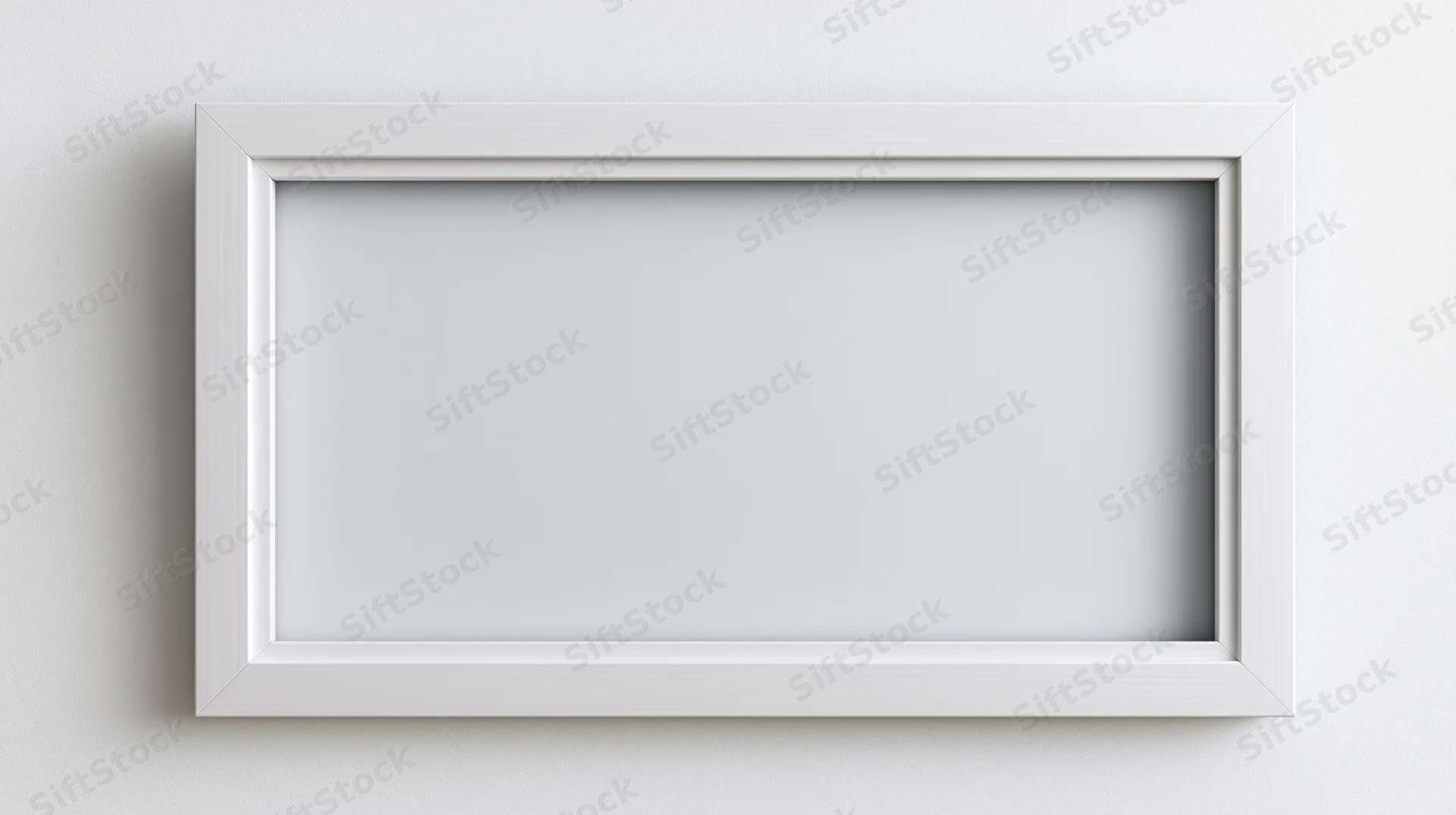 White empty picture frame centered on a plain wall