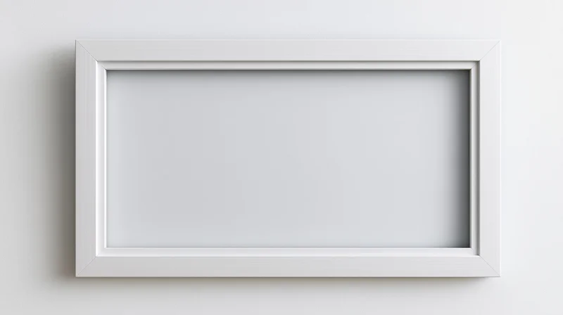 White empty picture frame centered on a plain wall