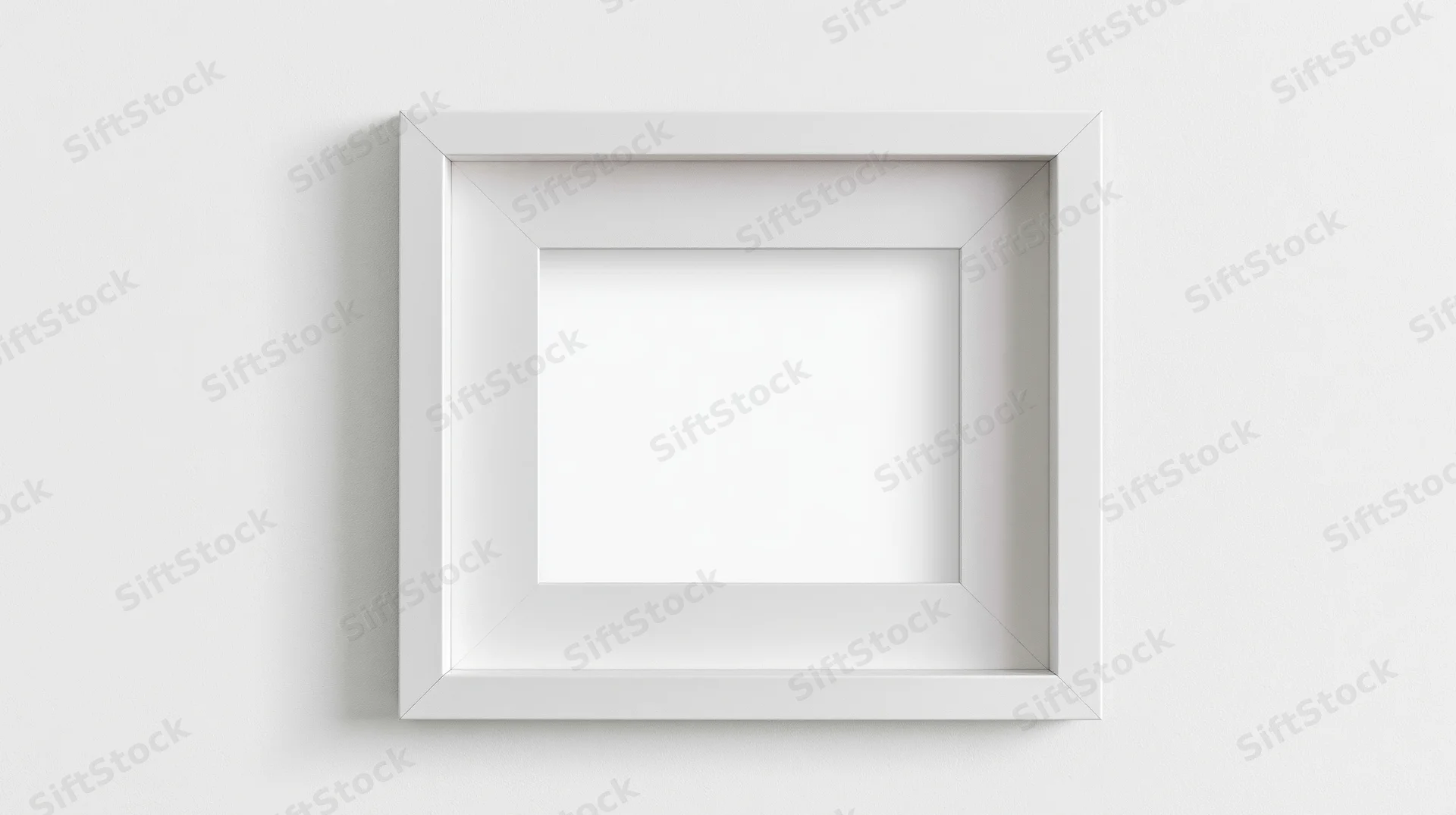 White empty picture frame centered on a plain wall