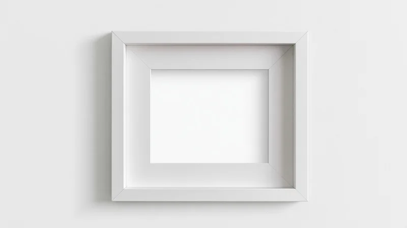 White empty picture frame centered on a plain wall