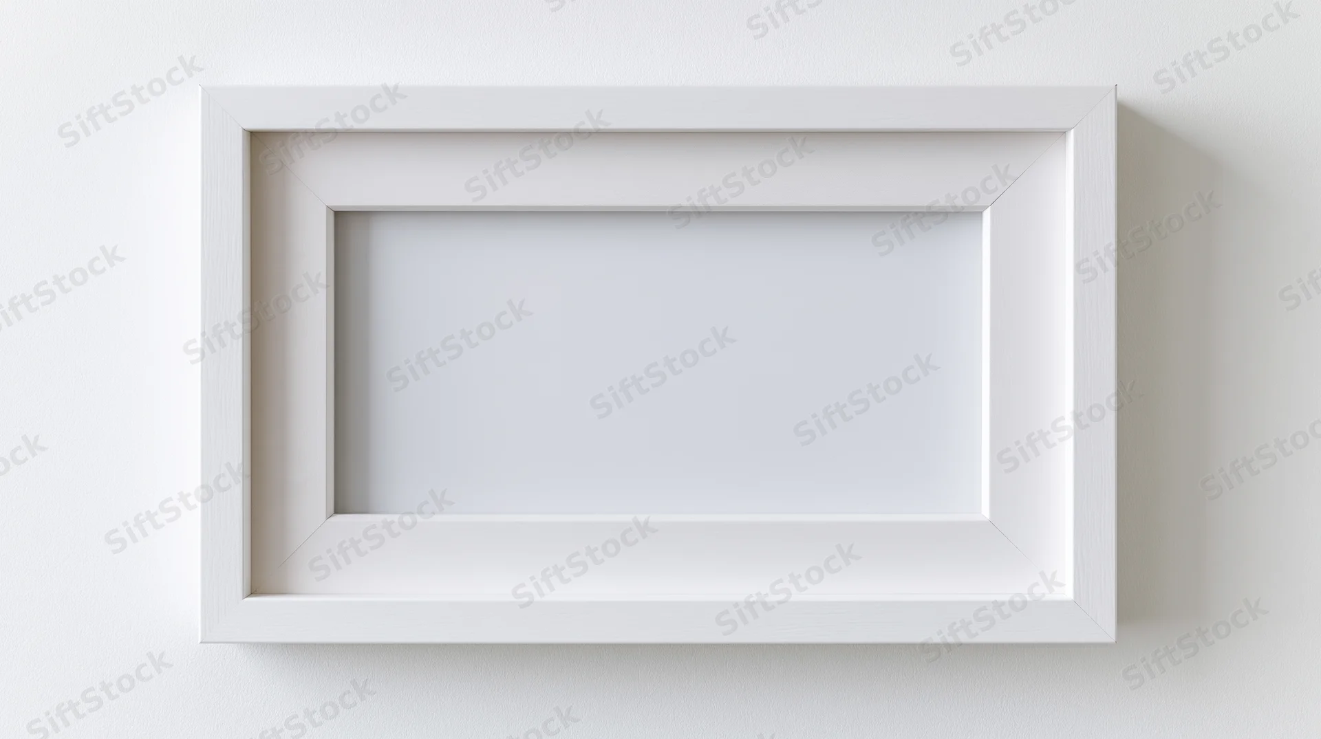 White empty picture frame centered on a plain wall