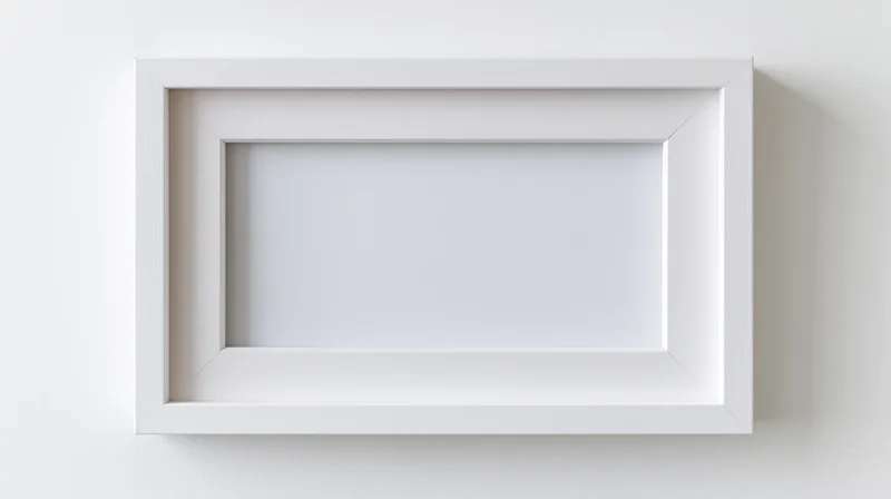 White empty picture frame centered on a plain wall
