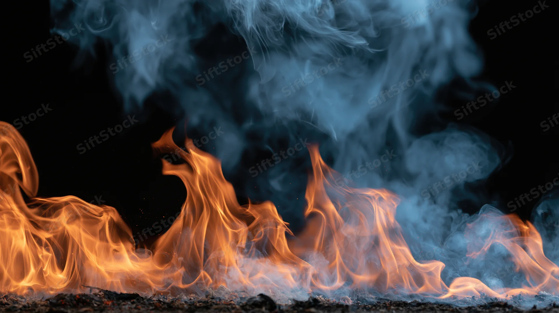Flames and rising smoke burning against a black background