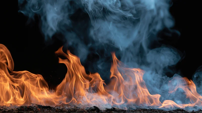 Flames and rising smoke burning against a black background