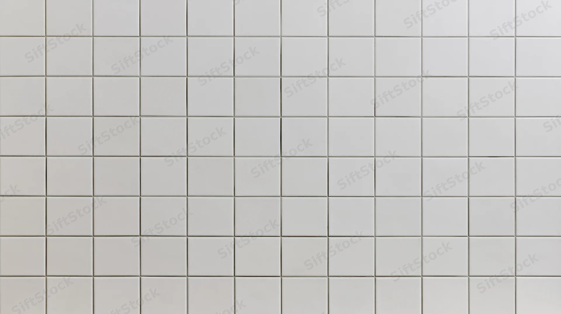 White ceramic square tiles arranged in a grid covering a wall