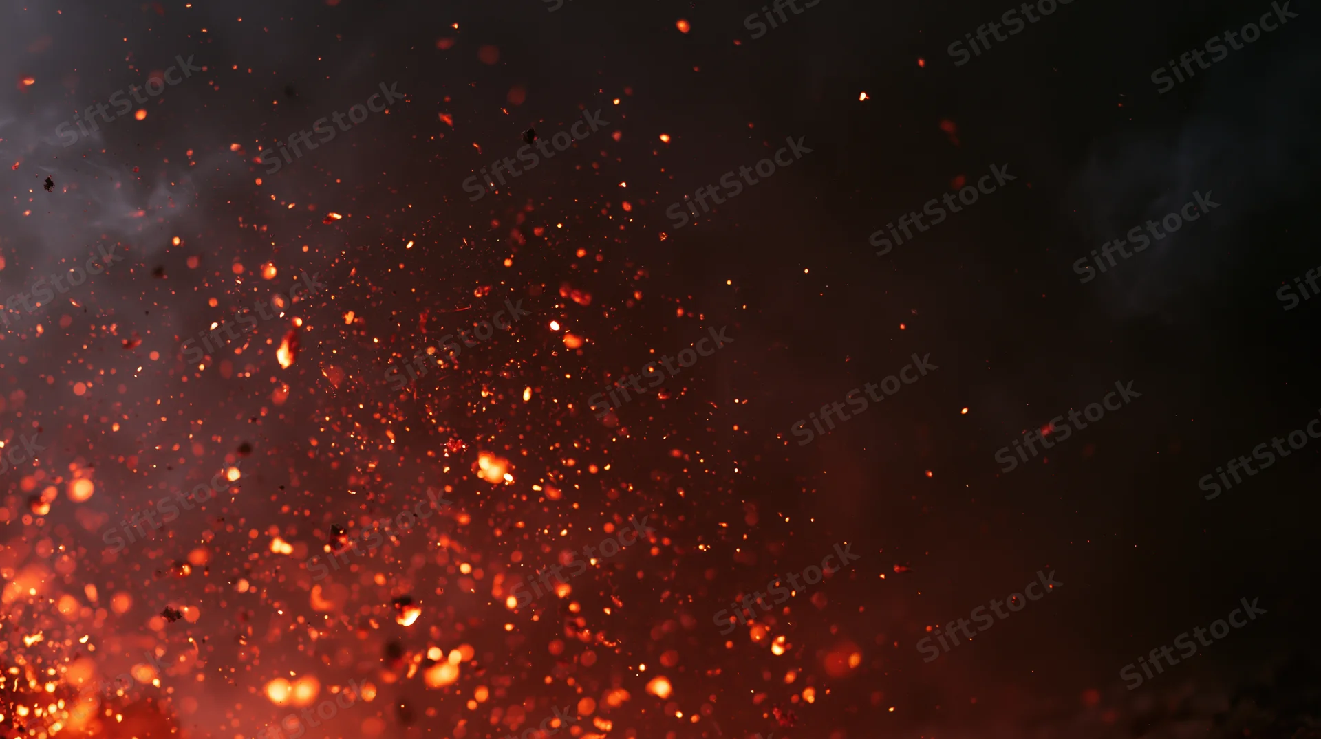 Glowing orange-red embers and fire sparks floating upward against a dark smoky background