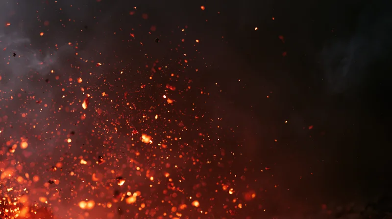 Glowing orange-red embers and fire sparks floating upward against a dark smoky background