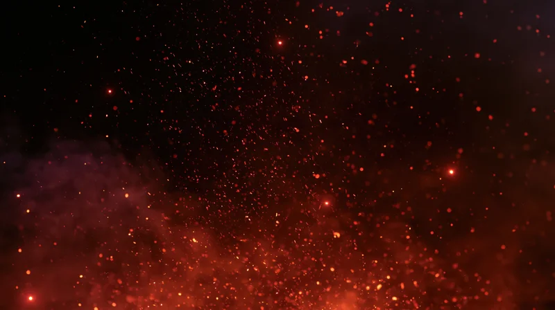 Glowing orange-red embers and fire sparks floating upward against a dark background