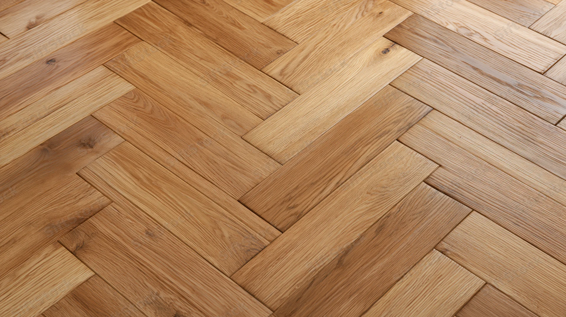 Herringbone parquet wood floor filling the frame with natural grain pattern