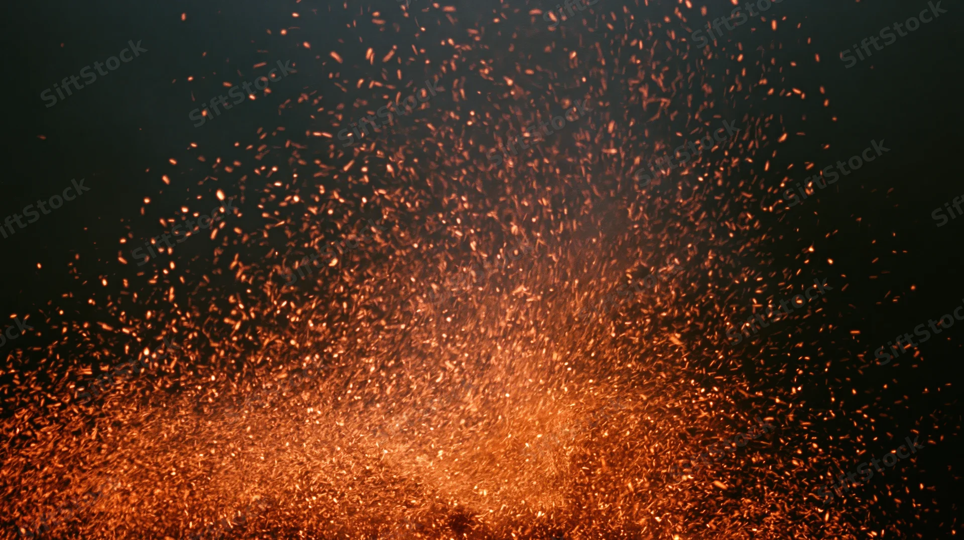 Glowing ember sparks rising and drifting upward against dark background