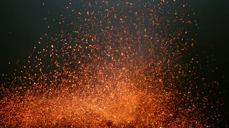 Glowing ember sparks rising and drifting upward against dark background