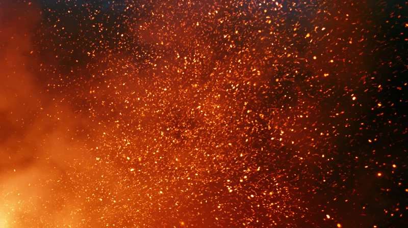 Glowing fire embers and sparks drifting upward in a fiery burst
