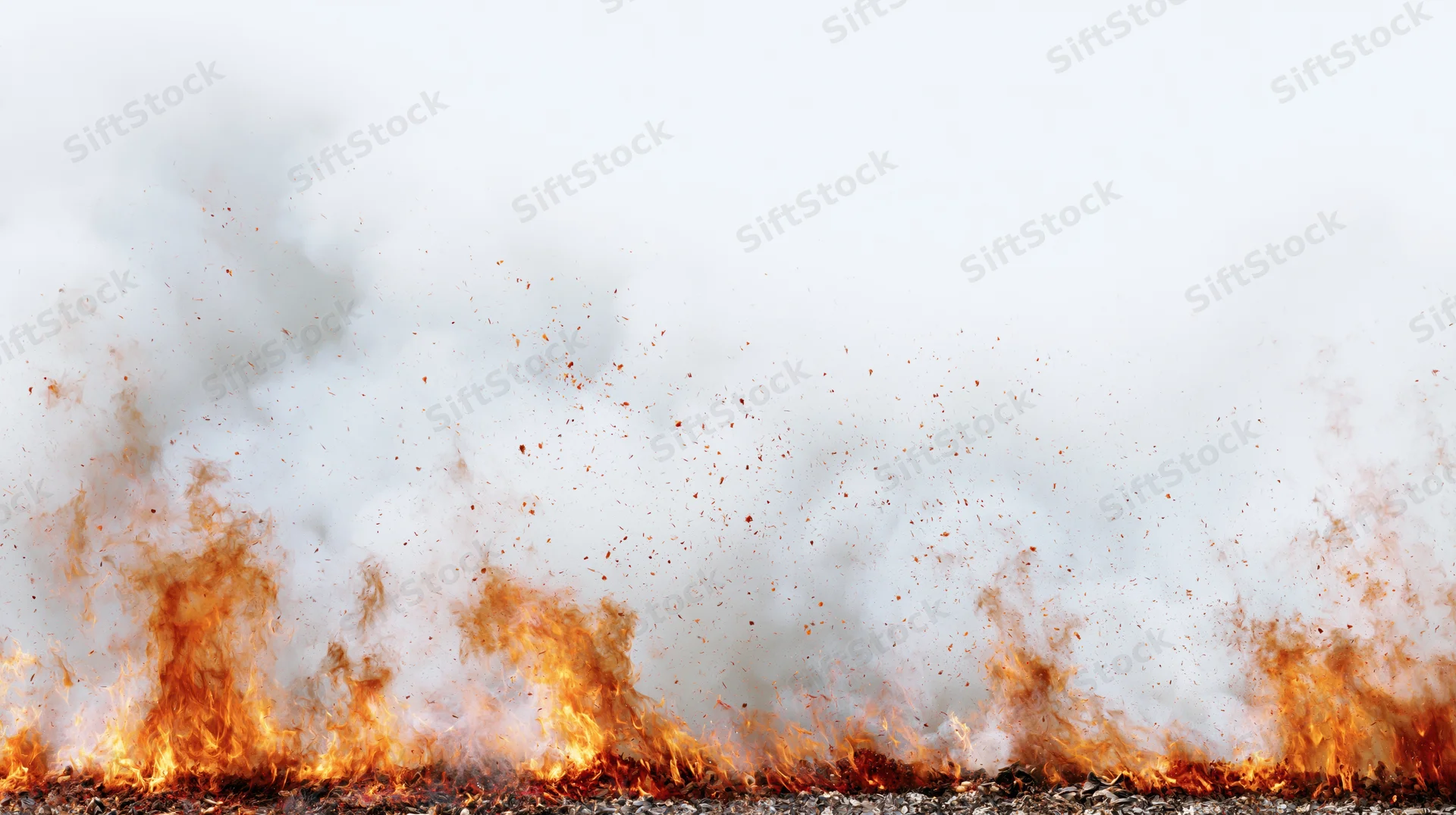 Intense fire flames burning along the bottom edge of the frame with rising smoke and embers