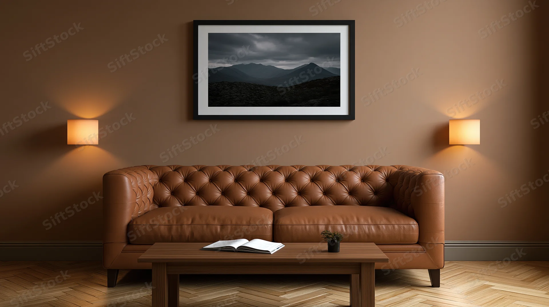 Tufted cognac leather sofa centered in a living room with wall sconces and framed mountain photo above