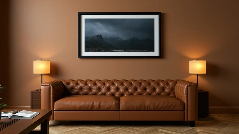 Tufted cognac leather sofa centered in a warm living room with wall art and lamps