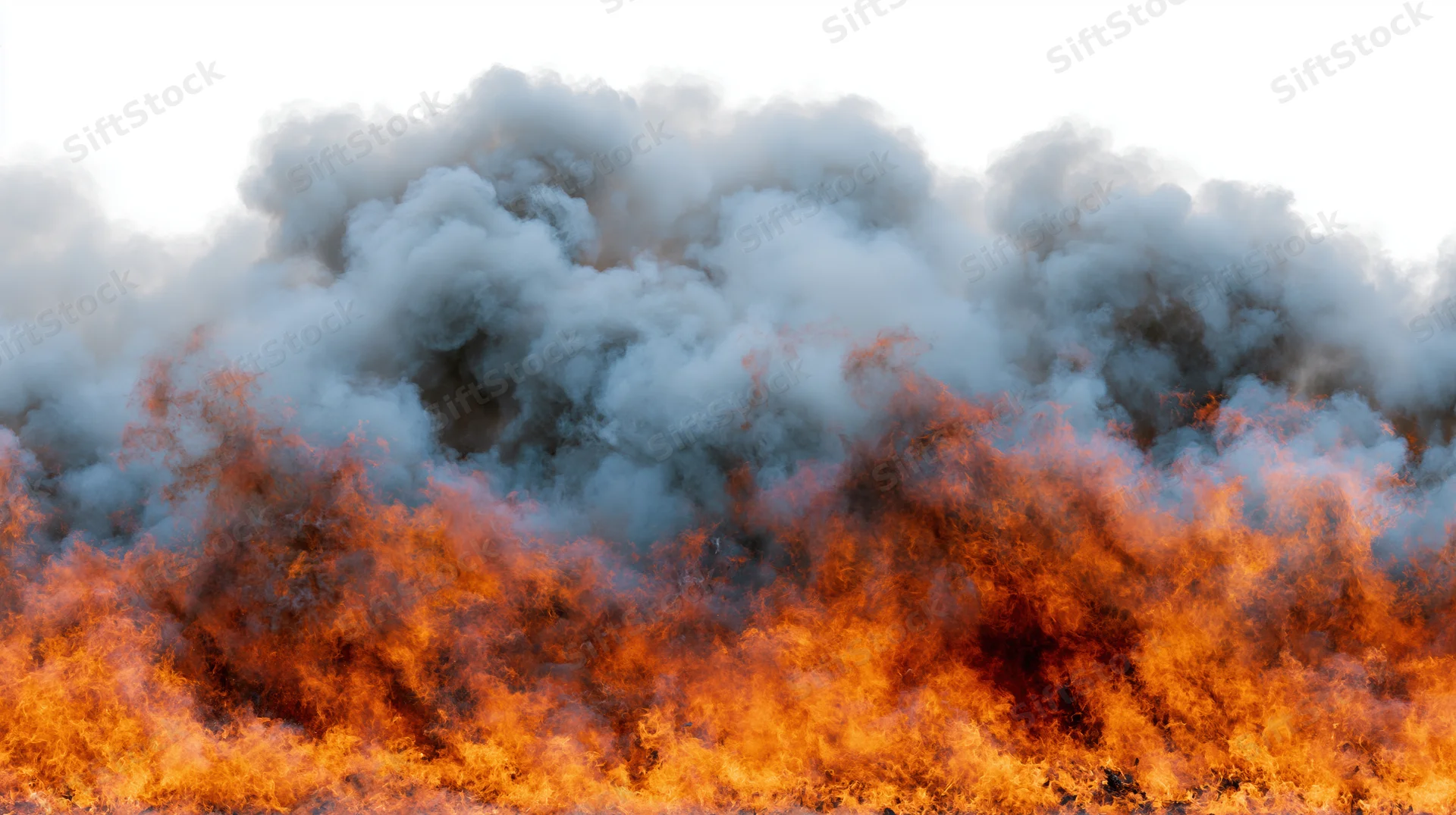 Intense flames and thick smoke rising from a large fire against a bright sky