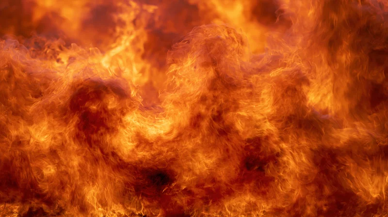 Billowing flames filling the frame in intense orange and red hues
