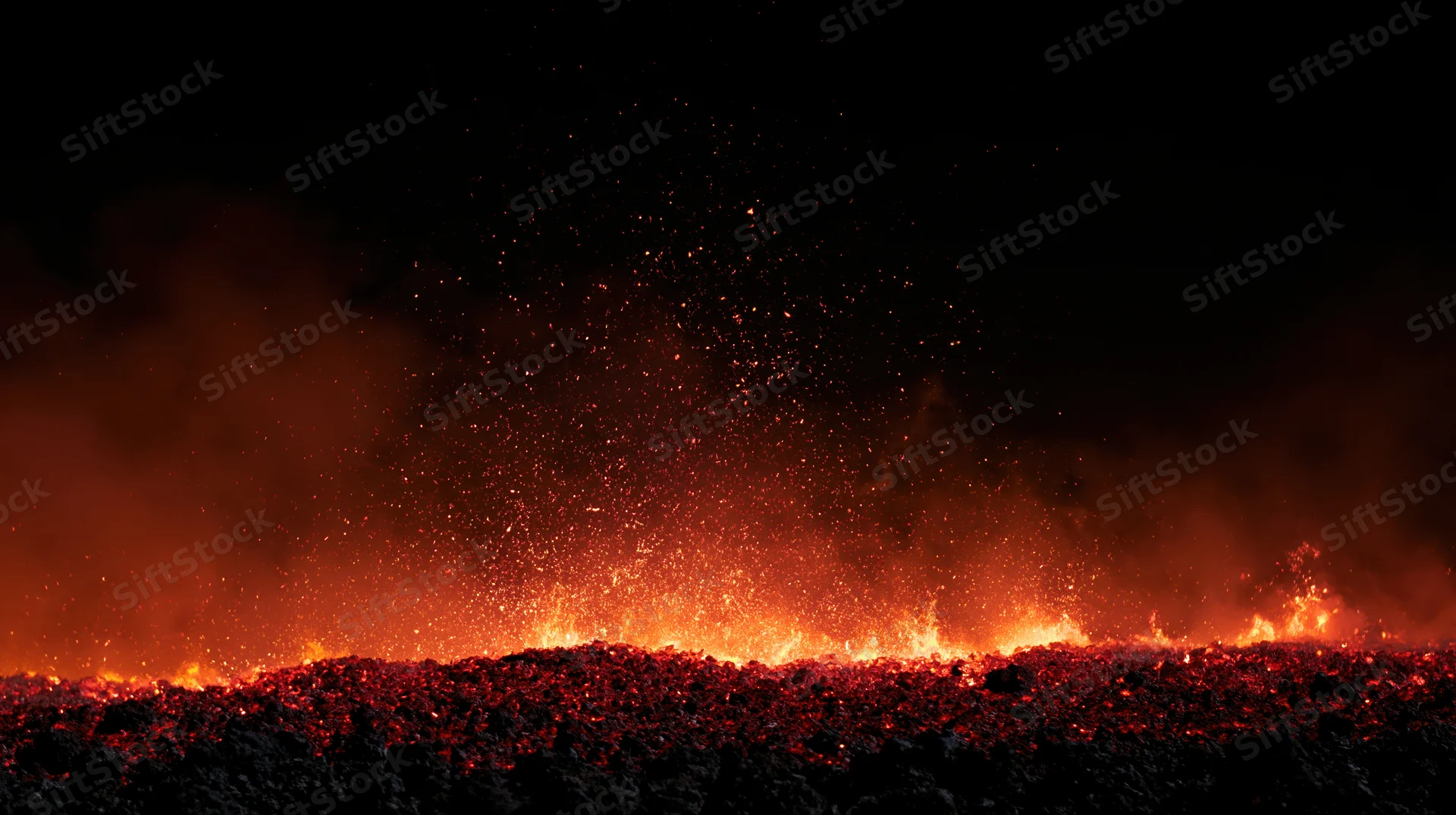 Glowing embers and sparks rising from molten lava at night
