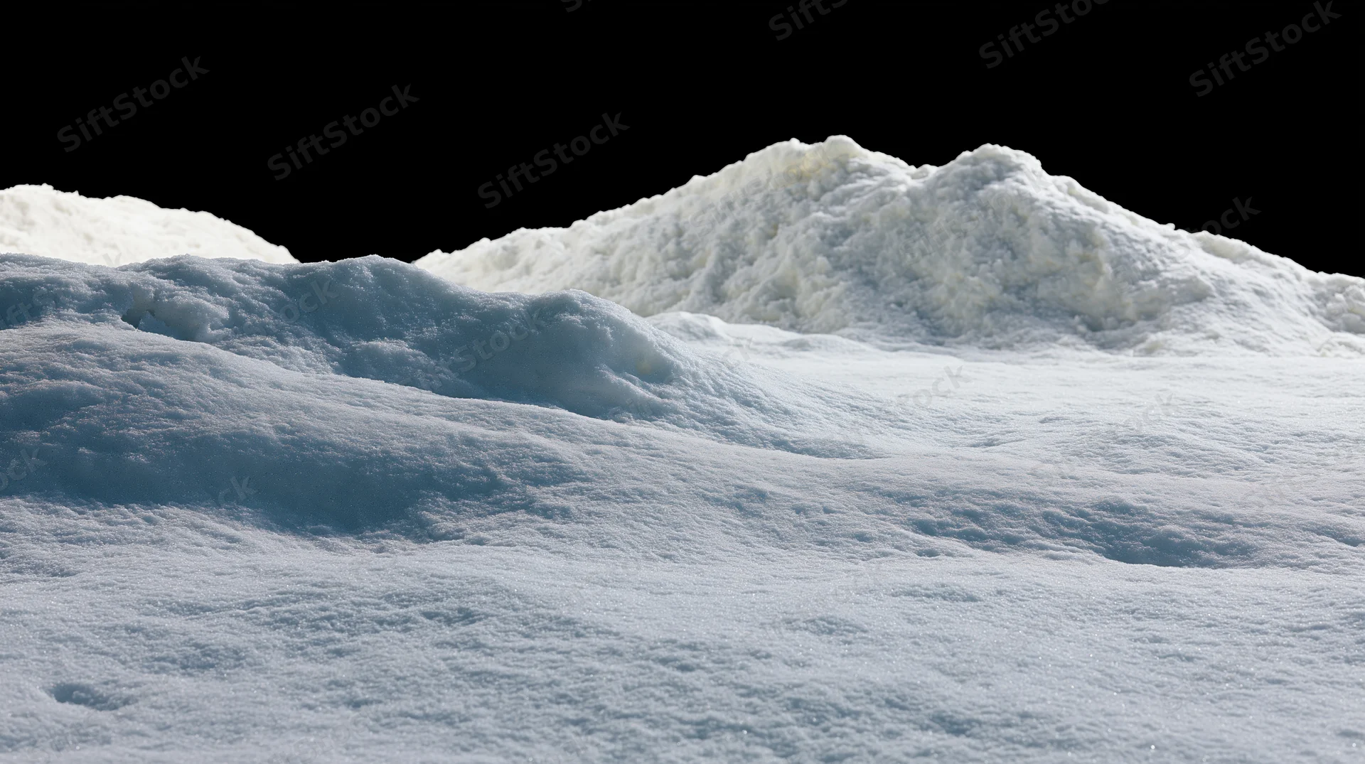 Snow-covered ground surface with gentle rises under dark sky