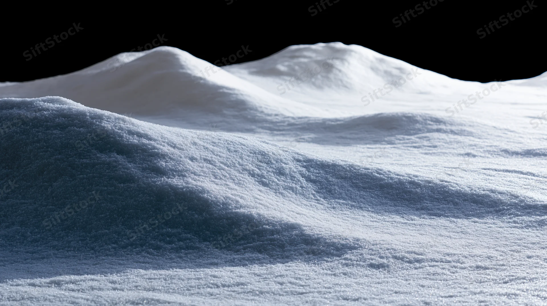 Snow-covered ground surface with gentle undulations under bright light against black sky