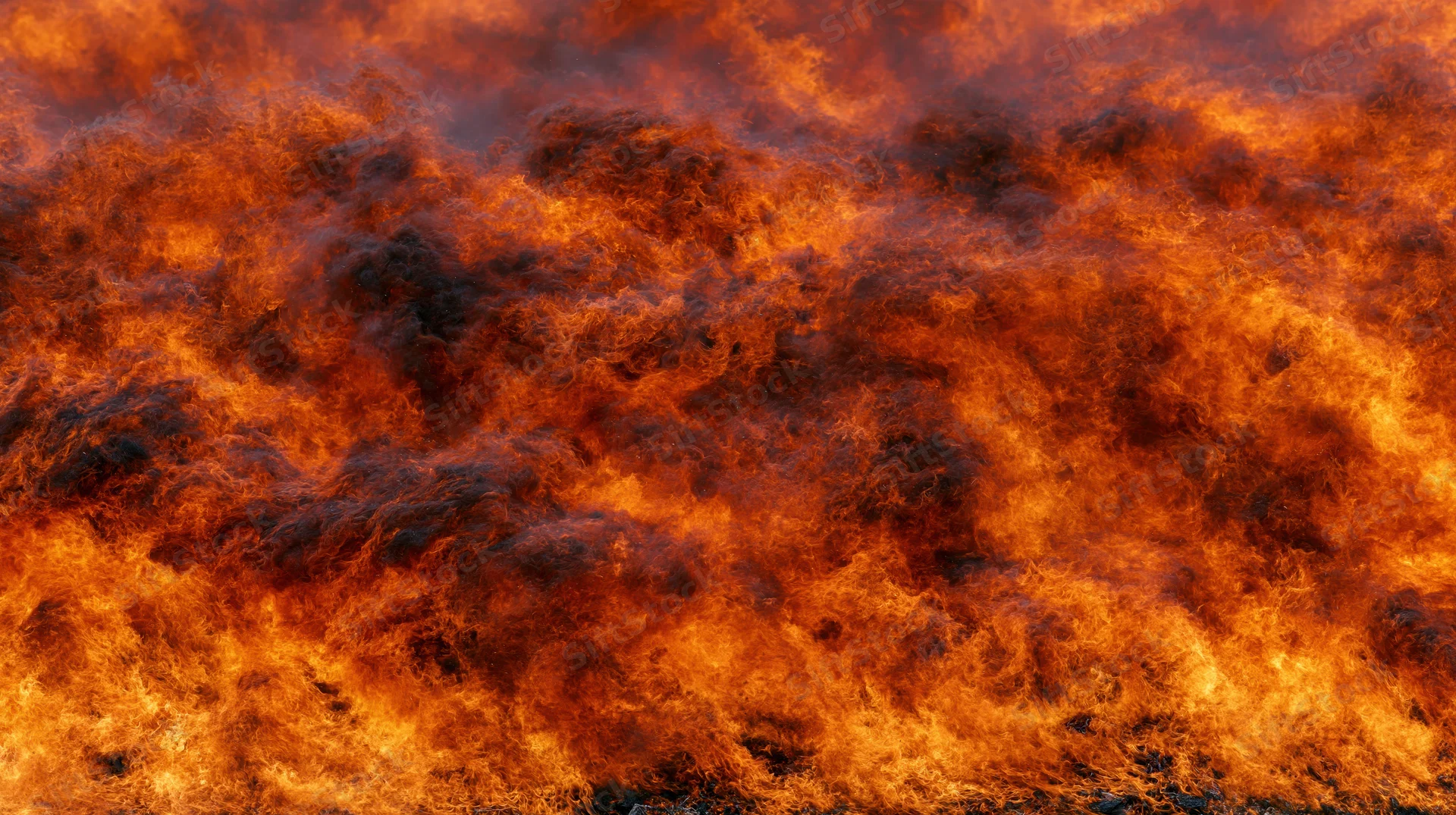 Massive wall of fire filling the frame in extreme close-up view