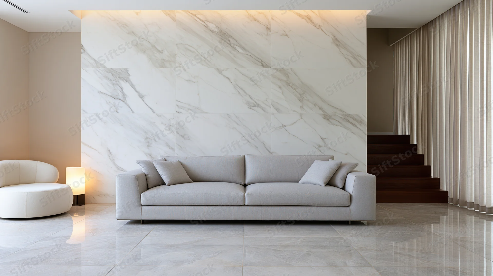 Light grey upholstered sofa in a minimalist luxury living room with marble wall and flooring