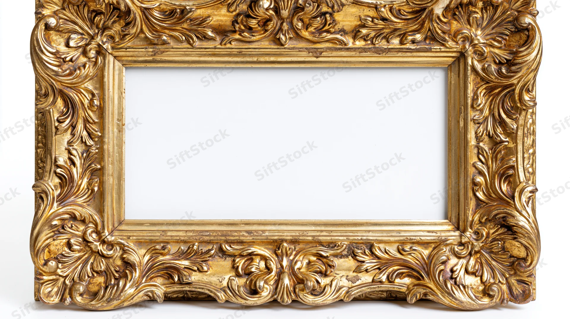 Ornate gilded picture frame with baroque carved floral details on white background
