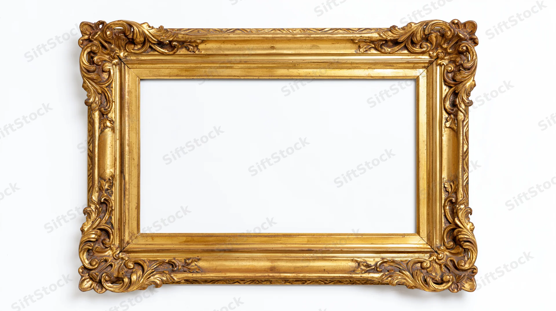 Ornate gold picture frame with baroque carved floral details isolated on white background