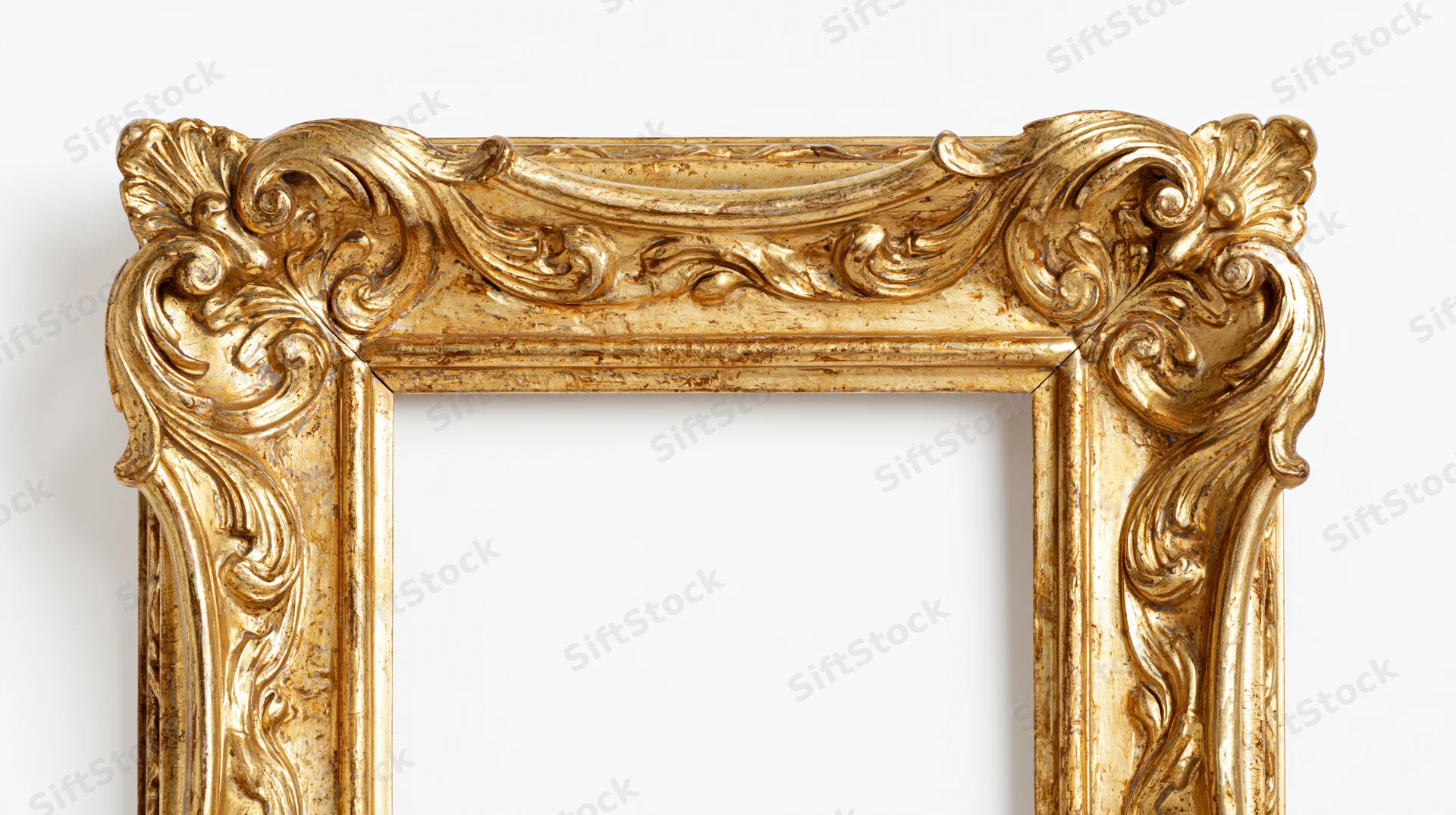 Ornate antique gold picture frame with baroque carved scrollwork against white background