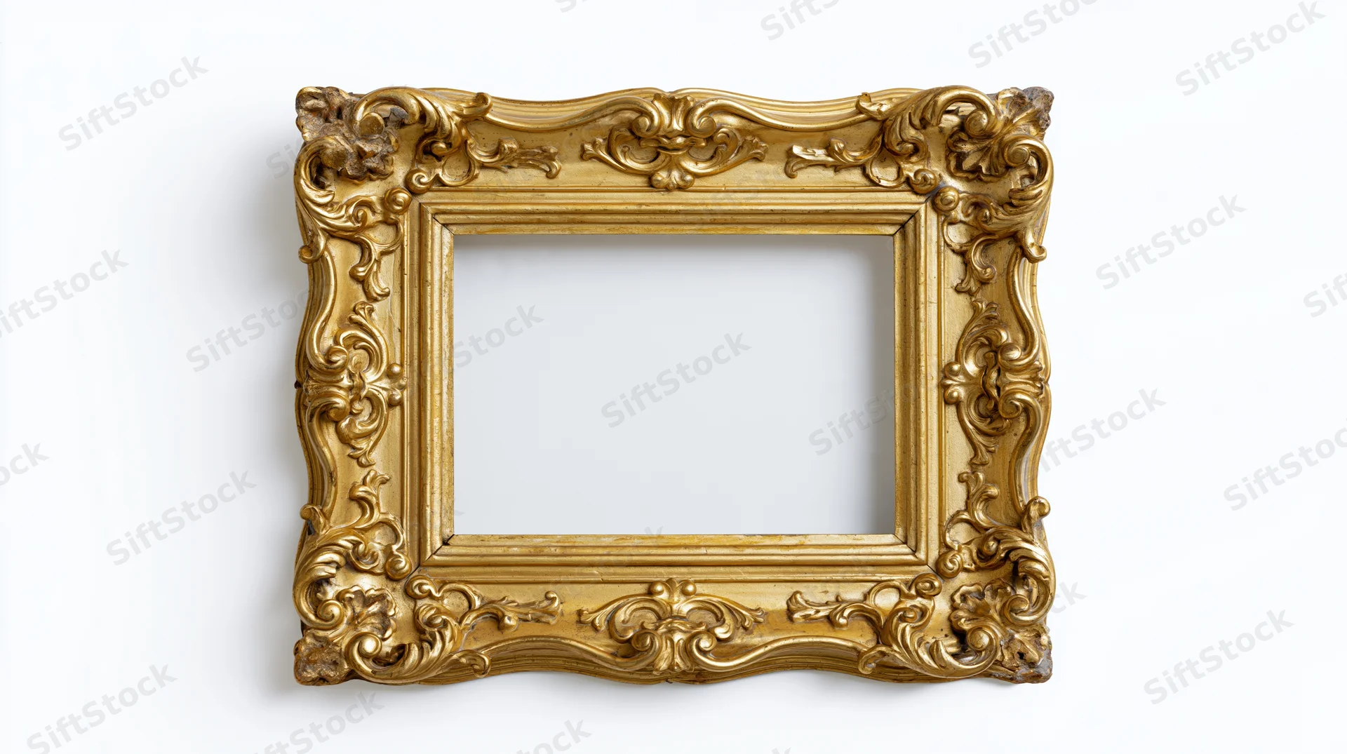 Ornate antique gold picture frame with elaborate baroque scrollwork isolated on white background