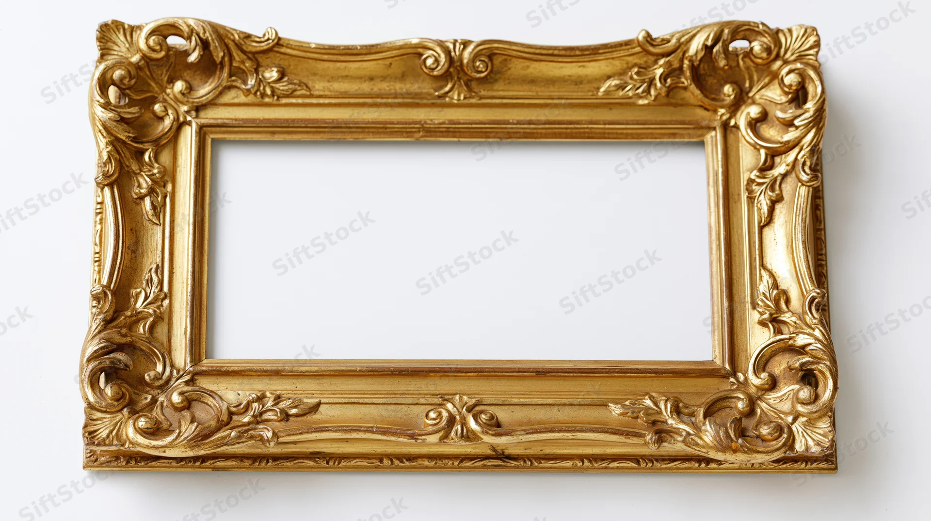 Ornate baroque gilt picture frame with carved scrollwork and empty center on white background
