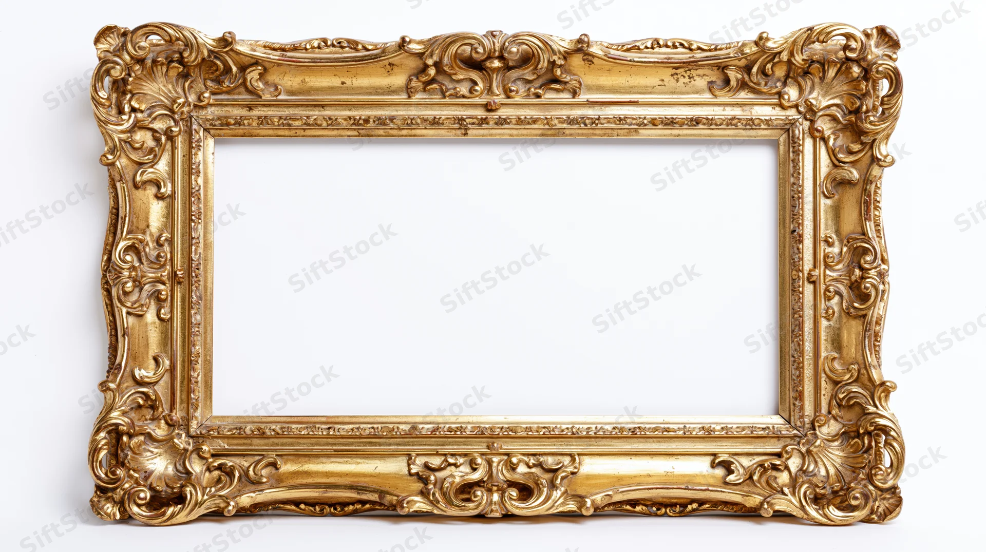Ornate baroque gilt picture frame with carved scrollwork isolated on white background