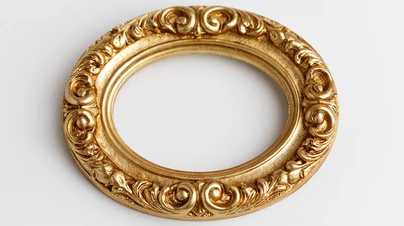 Ornate oval gold frame with baroque scroll and floral detailing on white background
