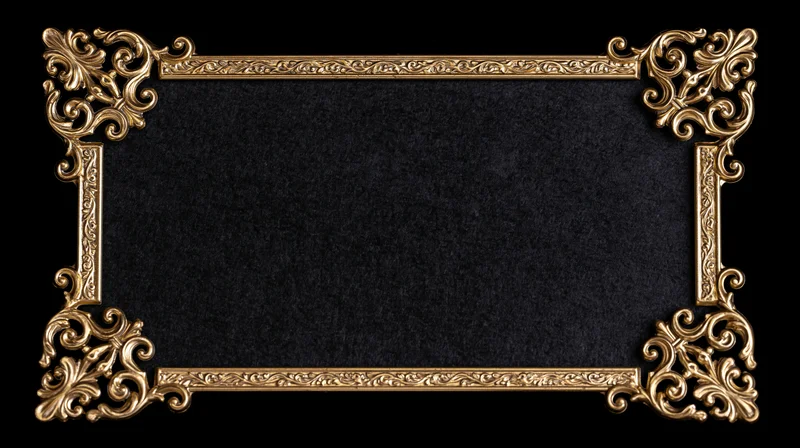 Ornate gold filigree frame with black textured center on black background