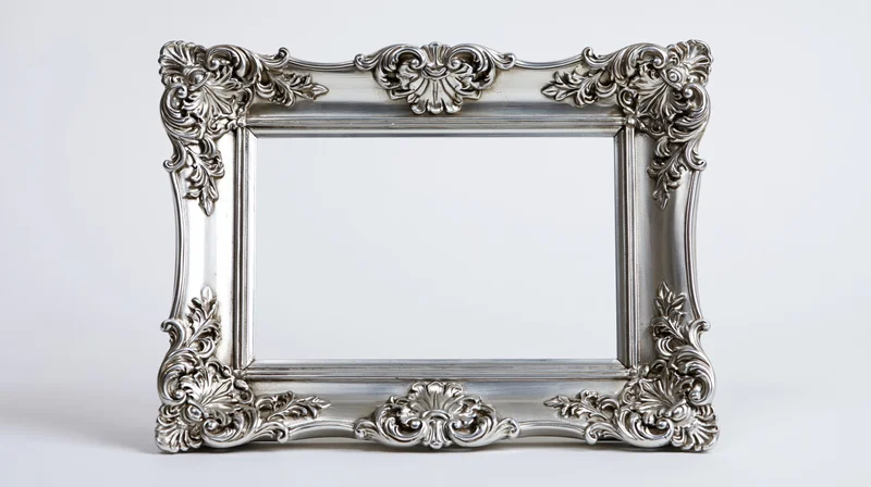 Ornate silver baroque picture frame with intricate scrollwork on white background