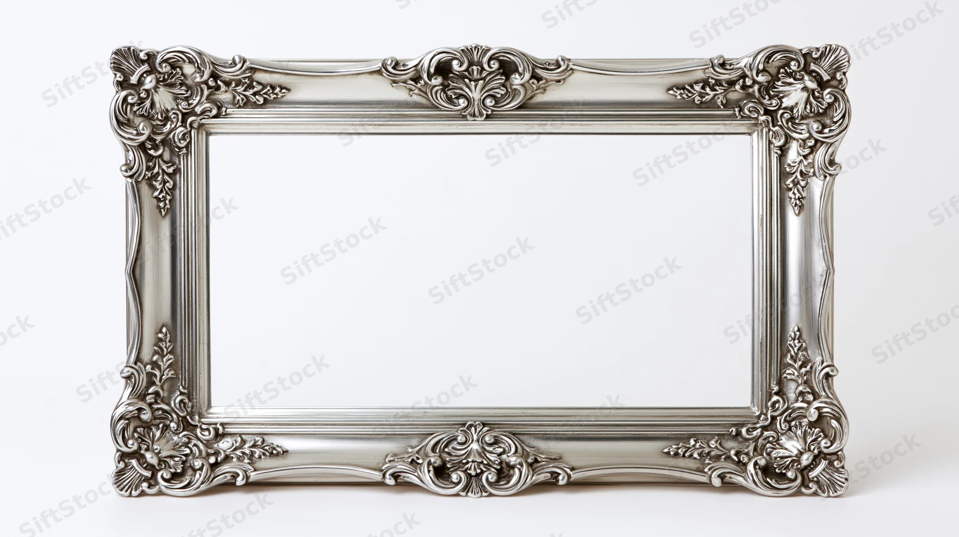Ornate silver baroque picture frame with intricate scrollwork on white background