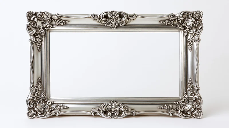 Ornate silver baroque picture frame with intricate scrollwork on white background
