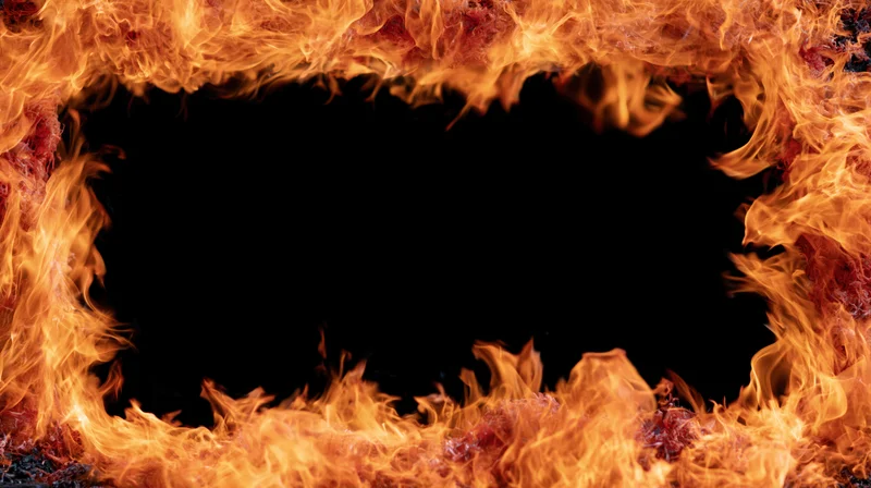 Rectangular frame of intense fire flames forming a border around a dark void