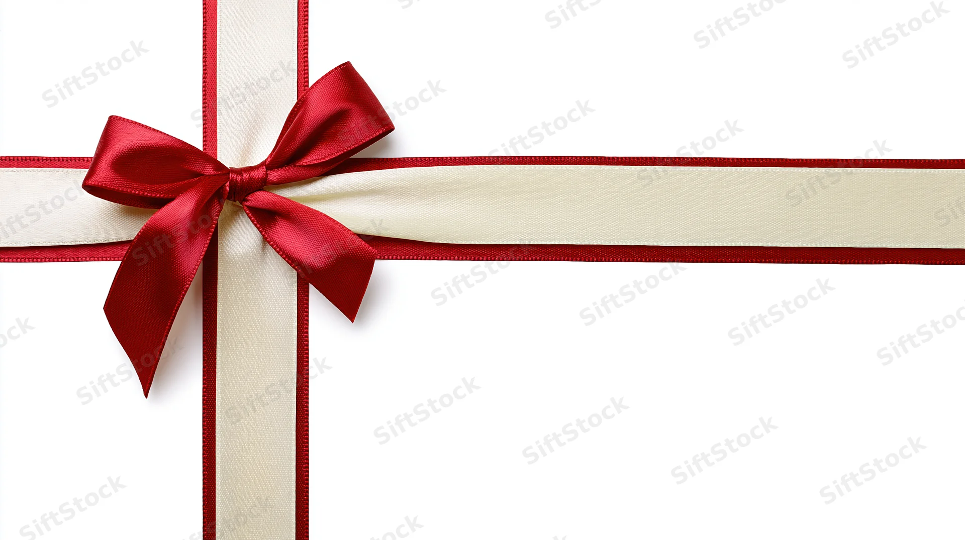 Red and cream satin ribbon tied in a bow crossing horizontally and vertically on white background